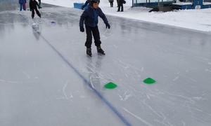Zdjęcie przedstawia uczniów klasy pierwszej podczas zajęć na lodowisku
